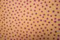 Preview: aprikotfarbener Baumwollstoff mit lila Punkten von Hilco