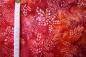 Preview: roter Batikstoff von Robert Kaufmann, Motiv: Blätter, Farben: rot-orange